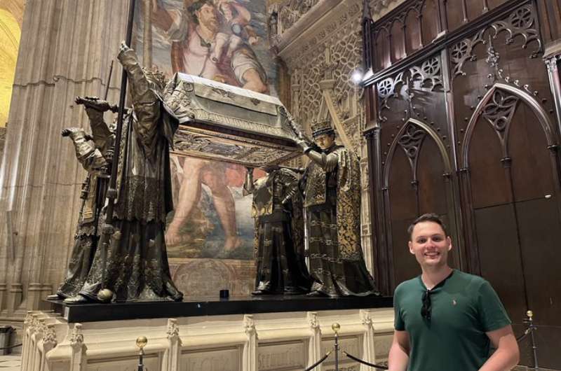 A tourist and the Christopher Columbus’ tomb in Seville, Spain 