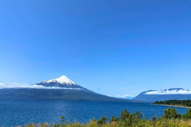 Lake Todos Los Santos in Chile with snowcapped mountain in background, photo by Next Level of Travel