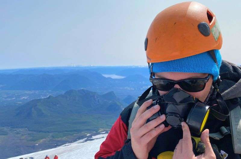 Traveler with an oxygen mask on Villarrica Volcano in Chile, photo by Next Level of Travel