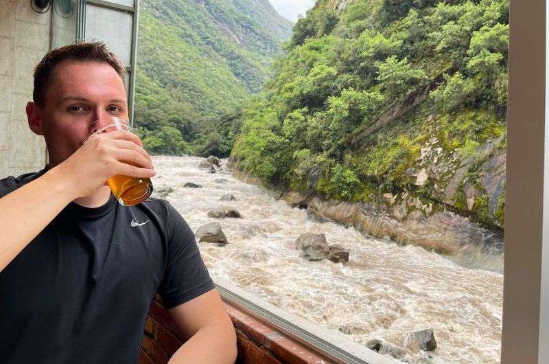 Tourist drinking beer on his visit to Machu Picchu, photo by Next Level of Travel