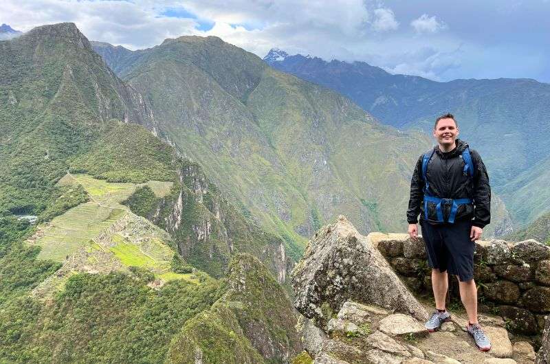 A traveler and the Machu Picchu view in Peru, photo by Next Level of Travel