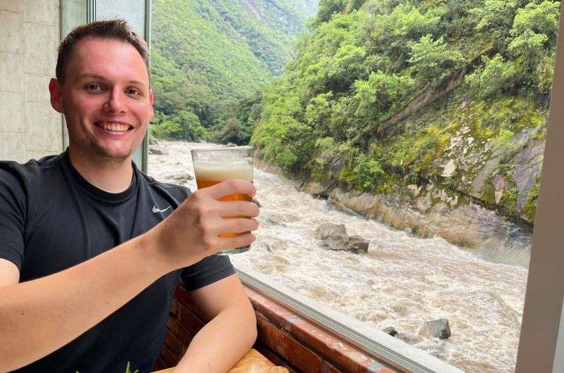 Traveler having a beer on his Machu Picchu trip in Peru, photo by Next Level of Travel