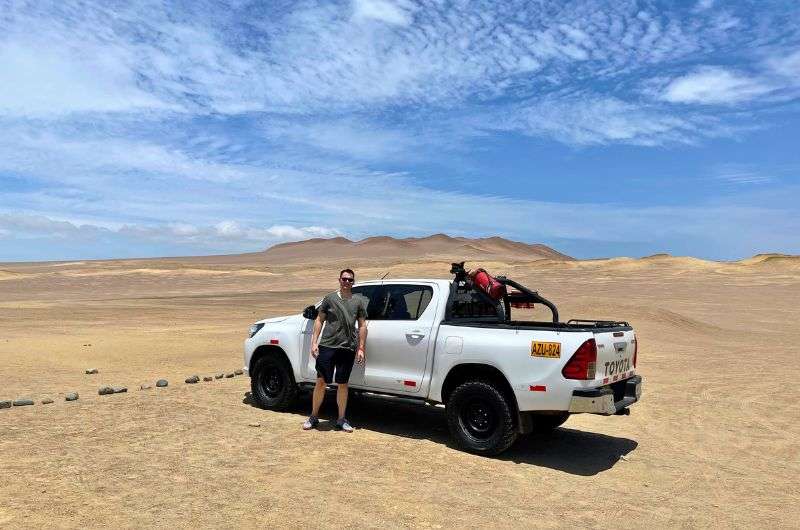 Tourist and a car in Paracas, Peru, photo by NExt Level of Travel