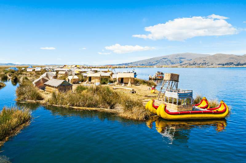 Reed islands with reed houses and boats of the Uros people on Lake Titicaca in Peru