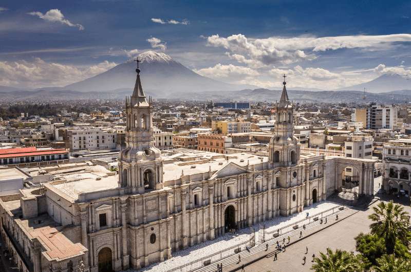 The white cathedral on the main square of Arequipa with El Misti volcano in the background