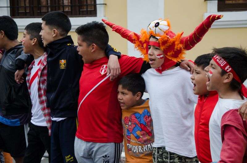 peruvians holding each other and singing