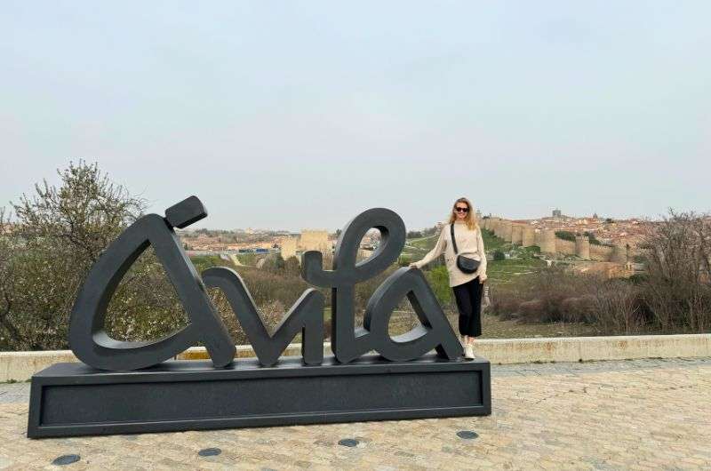 A female in front of the Ávila sign, Spain, itinerary , photo by Next Level of Travel