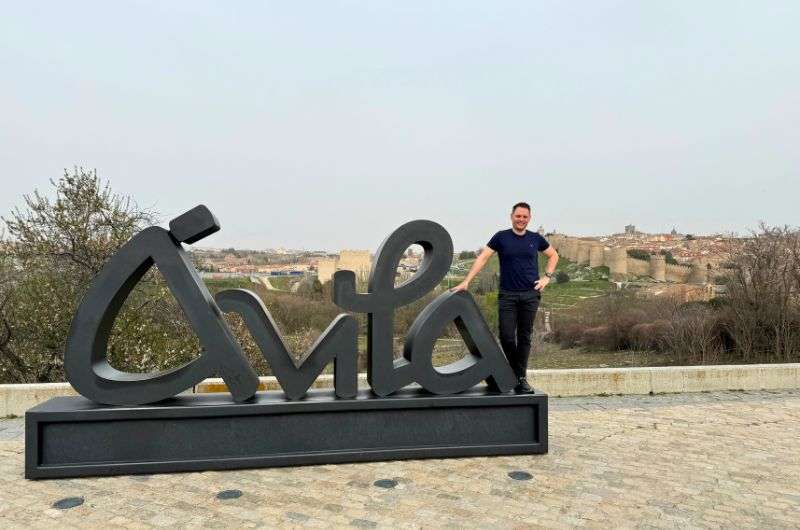 A male in front of the Ávila sign, Spain, itinerary , photo by Next Level of Travele