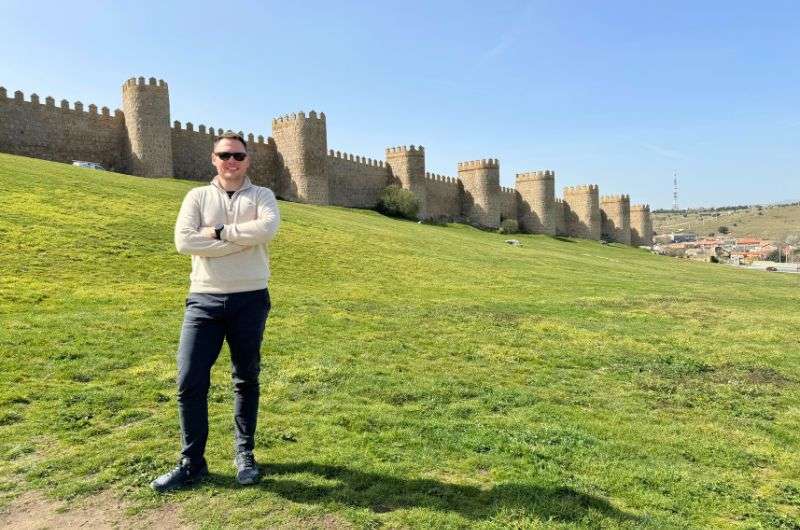 A tourist in front of the Murallas de Ávila in Ávila, Spain, picture by Next Level of Travel