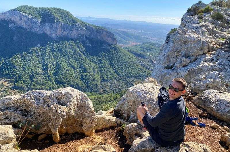 A tourist enjoying the view of Tramuntana Mountains in Palma de Mallorca, photo by Next Level of Travel