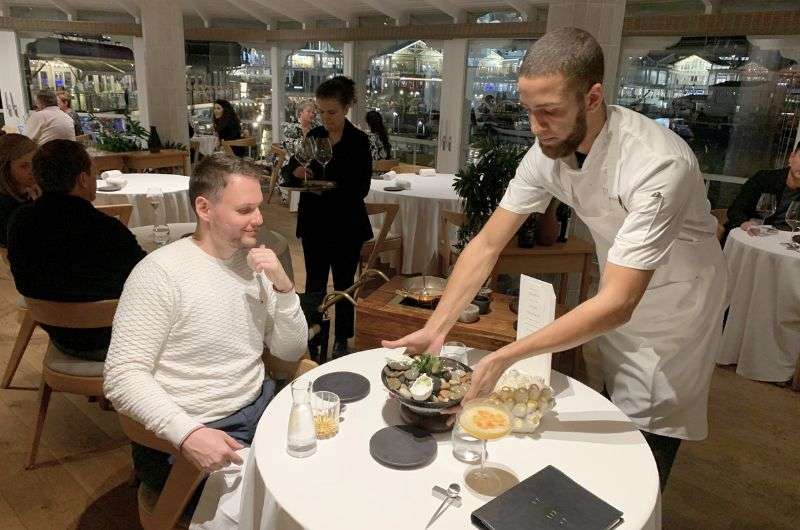 A tourist getting food in a restaurant in Cape Town, South Africa, photo by Next Level of Travel