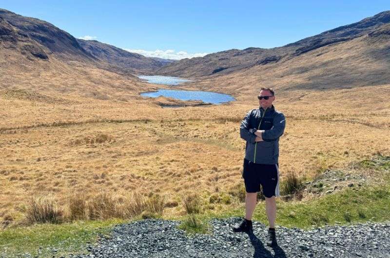 A tourist at the Three Lochs Viewpoint on Isle of Mull, Scotland, photo by Next Level of Travel