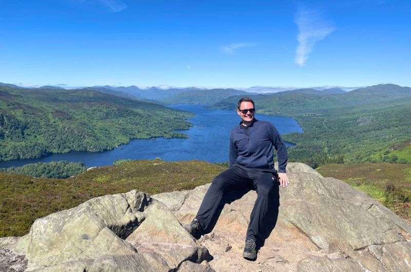 A tourist visiting Loch Lomond in Trossachs, Scotland itinerary, photo by Next Level of Travel 