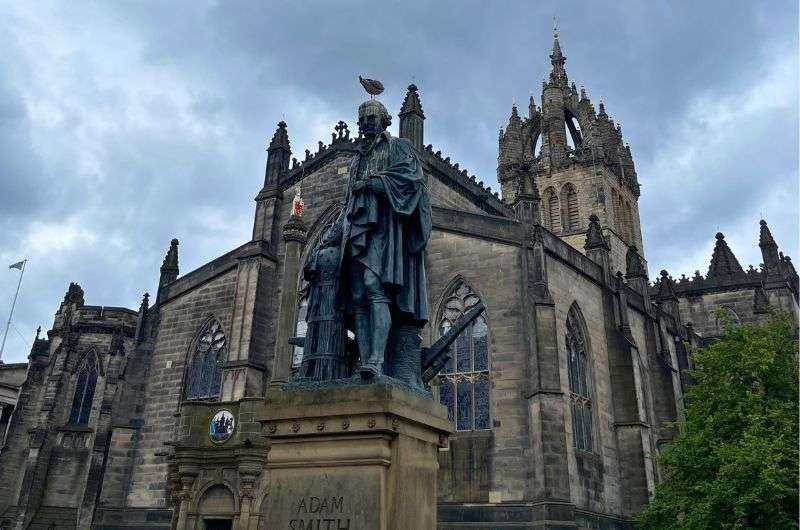 The Adam Smith Statue in front of St. Giles’ Cathedral in Edinburgh, photo by Next Level of Travel