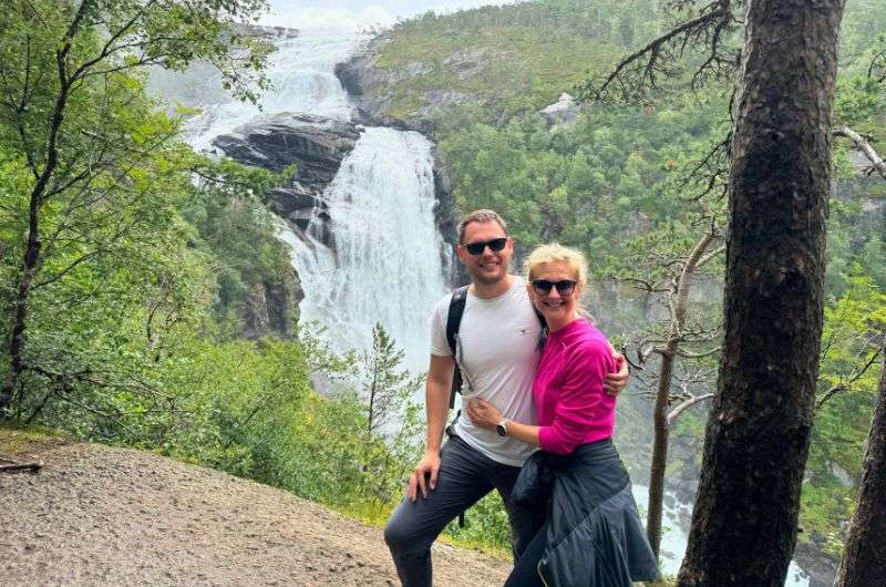 Travelers and the waterfall on Nykkjesøyfossen hike in Norway, photo by Next Level of Travel