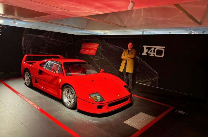 Traveler and a ferrari car in Ferrari museum, Modena, photo by Next Level of Travel