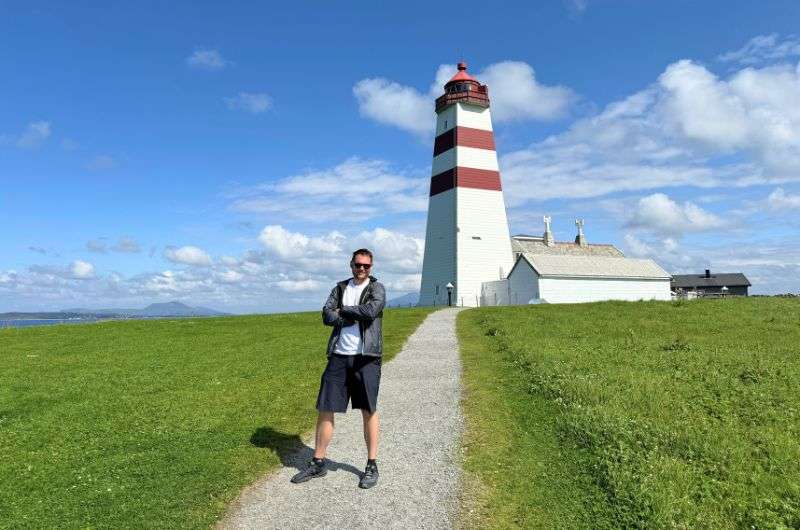 Traveler in front of the Alnes light house in Ålesund, Norway, photo by Next Level of Travel