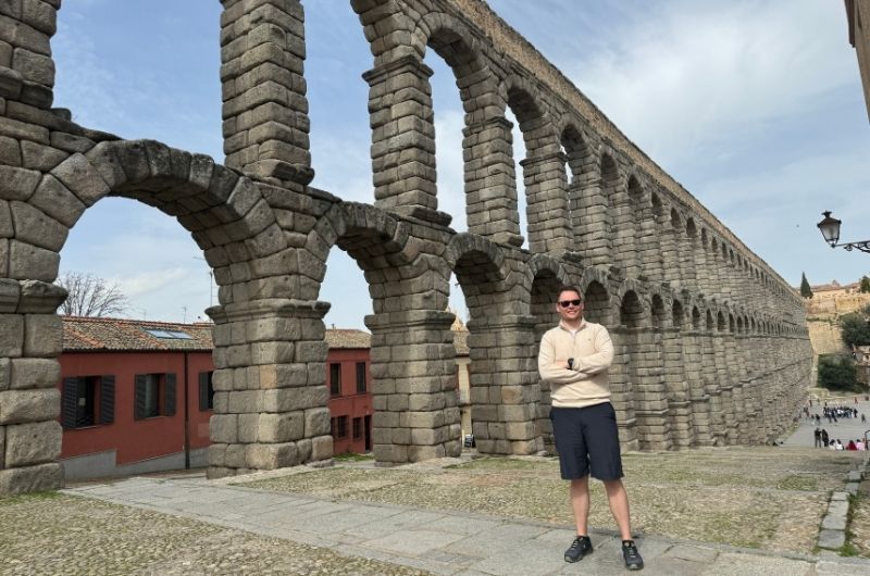 Tourist at the aqueduct in Segovia, Spain, photo by Next Level of Travel   The Aqueduct 