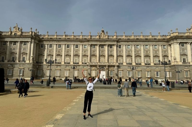 Tourist in front of Royal Palace in Madrid, Spain, photo by Next Level of Travel   Royal Palace in Madrid