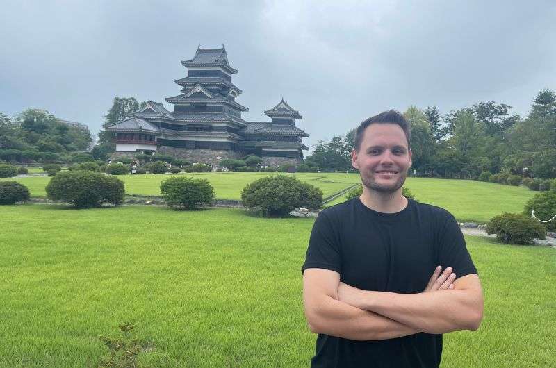 Traveler in front of Matsumoto Castle in Nagano, photo by Next Level of Travel 